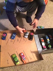 This Awesome Toddler Matching Activities Using Cars and a DIY Garage is Super Easy to Make and Your Toddler will Enjoy this Activity Over and Over again.