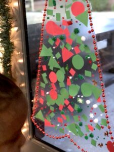 This Christmas Tree Craft For Kids Will Be A Hit For The Holidays! This Activity Uses Contact Paper To Create A Fun And Unique Christmas Craft Experience. #christmascrafts #christmascraftsforkids