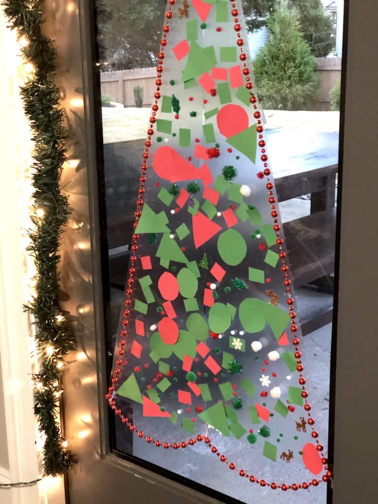 This Christmas Tree Craft For Kids Will Be A Hit For The Holidays! This Activity Uses Contact Paper To Create A Fun And Unique Christmas Craft Experience. #christmascrafts #christmascraftsforkids