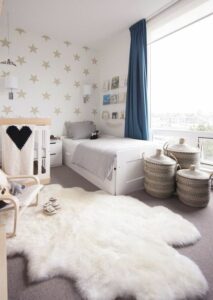 neutral-shared-room-with-a-star-print-wall-some-neutral-furniture